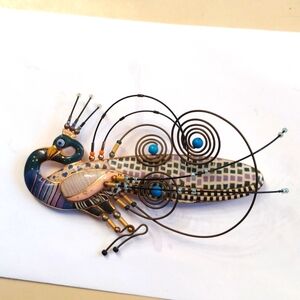 Whimsical peacock brooch